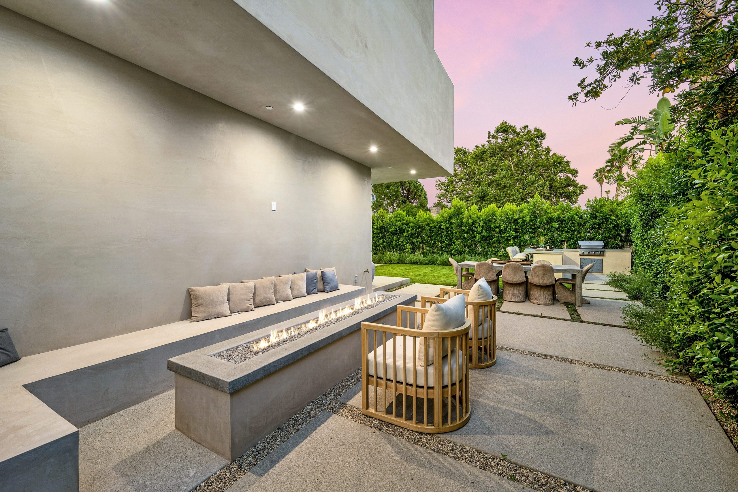 An,Outdoor,Table,And,Chairs,On,A,Patio,With,Green
