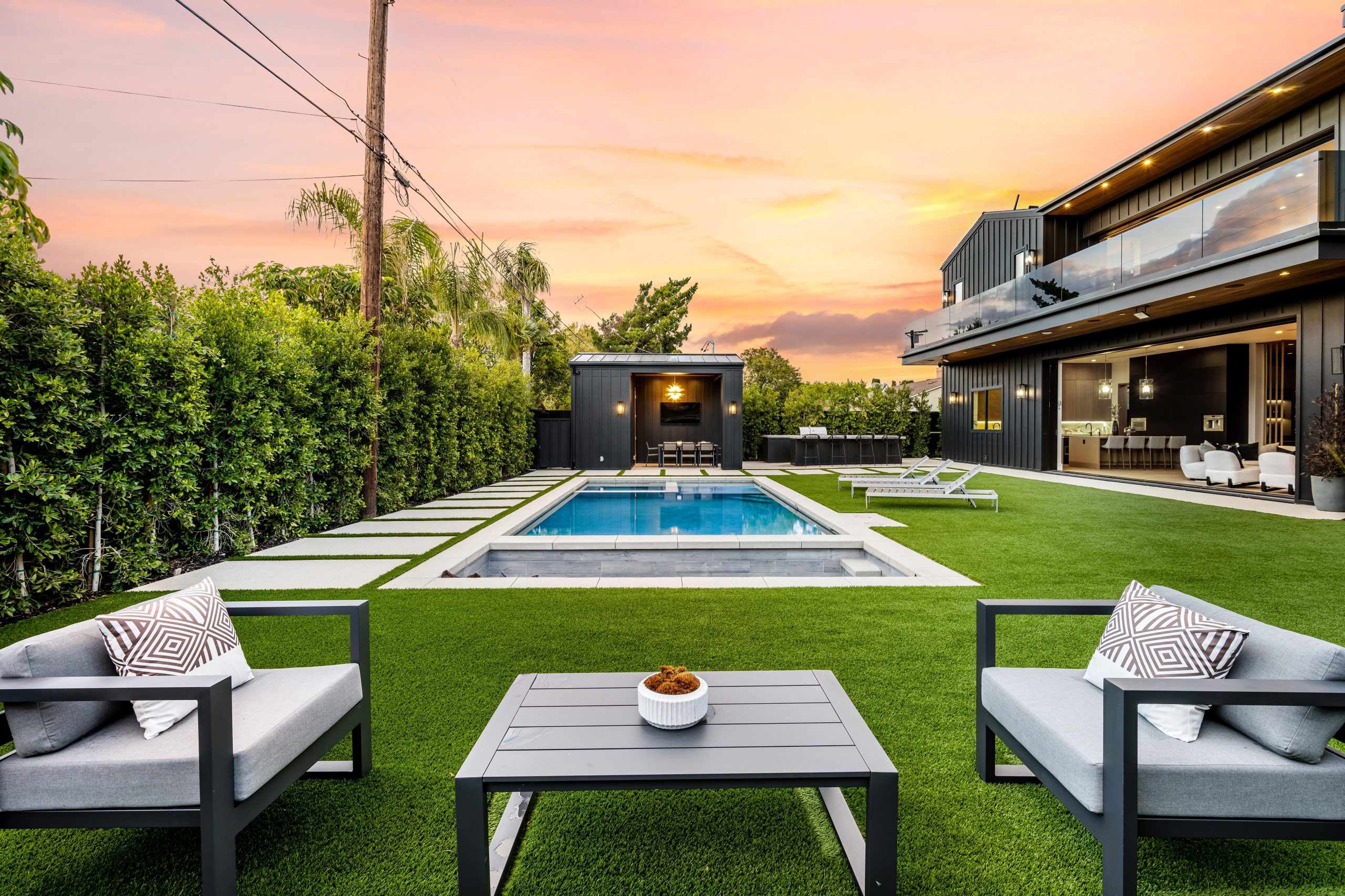 A,Modern,Backyard,With,A,Swimming,Pool,,Seating,Area,,And